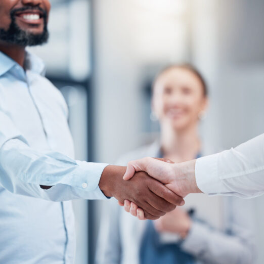 Shot of two unrecognizable businesspeople shaking hands in an office at work. Shot of two unrecognizable businesspeople shaking hands in an office at work.